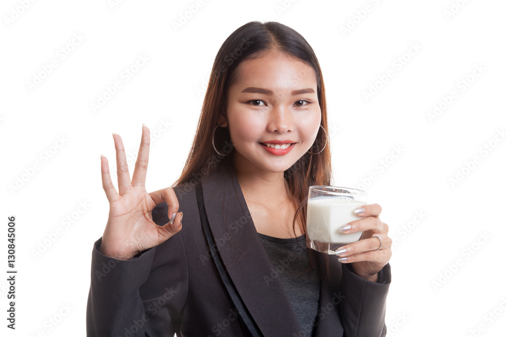 Healthy Asian woman drinking a glass of milk show OK sign. Healthy Asian woman drinking a glass of milk show OK sign.