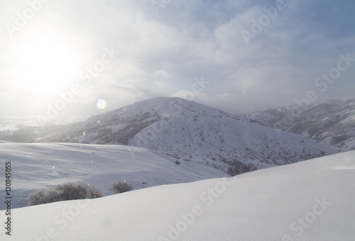 dawn sun in the snowy mountains of Kazakhstan © schankz
