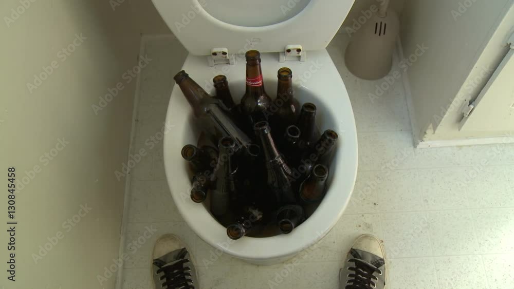 Beer Bottle Toilet Flush. Funny static point of view (POV) shot of a