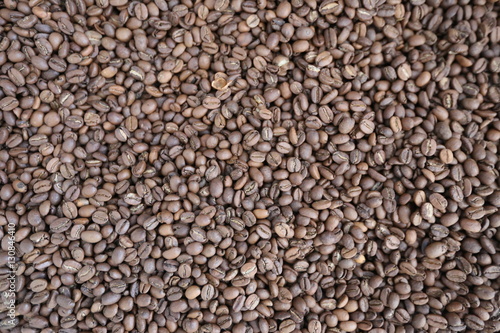Roasted brown coffee beans background, above view. Coffee beans texture