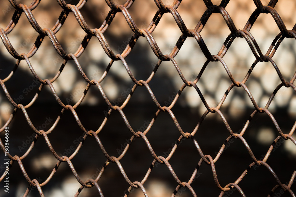 Fototapeta premium Metallic rusty fence in a grid background