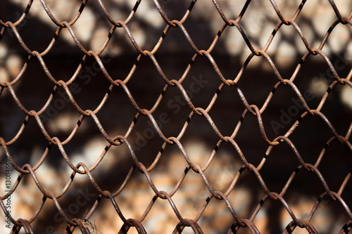 Metallic rusty fence in a grid background