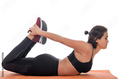 Sport girl doing yoga isolated on white background
