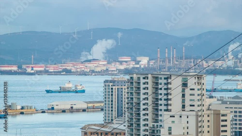 Gibraltar View to Refineries at Puente Mayorga Spain with Cargo Ships in the Bay and Apartment Buildings against the Harbor Water