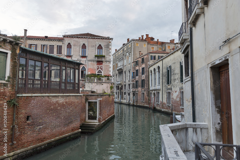 Venice cityscape, narrow water canal and traditional buildings.