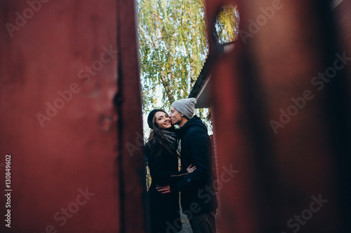 Couple of lovers. Beautiful couple in love in warm clothes kissing outdoors. Autumn love story.