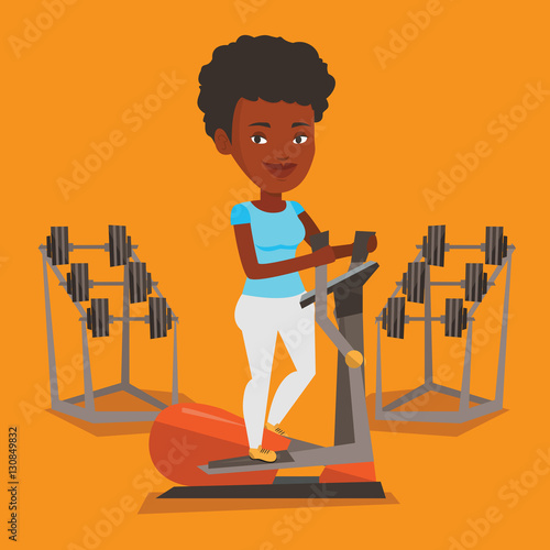 Woman exercising on elliptical trainer.