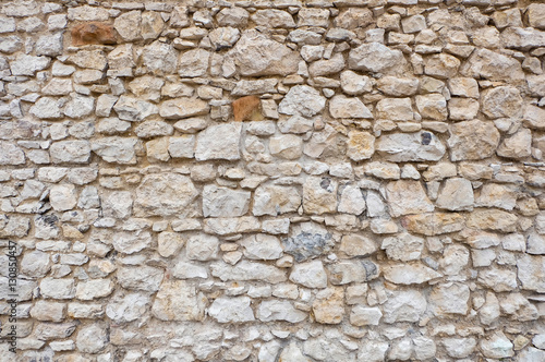 stone wall of a ancient fortress with white blocks