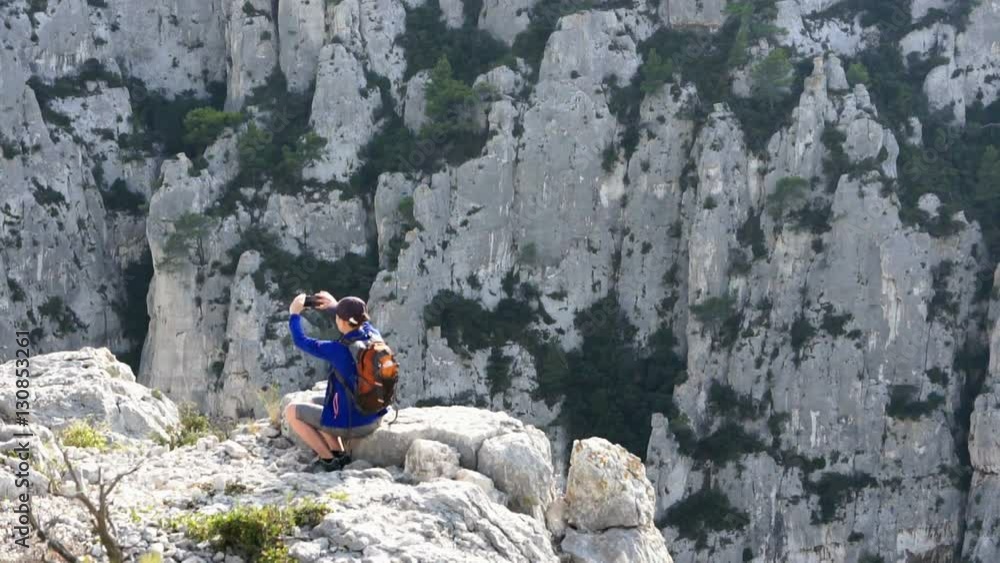 Young woman uses a smartphone to video a beautiful view in the mountains Young woman uses a smartphone to video a beautiful view in the mountains