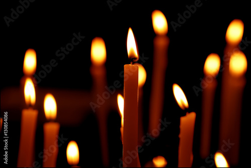 Burning candles over black background