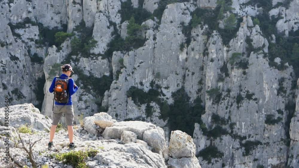 Young female tourist enjoying beautiful view in the mountains, Calanques, France Young female tourist enjoying beautiful view in the mountains, Calanques, France