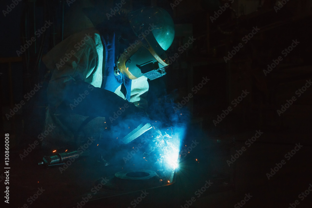 Welder of Metal Welding with sparks and smoke in steel industry Welder of Metal Welding with sparks and smoke in steel industry