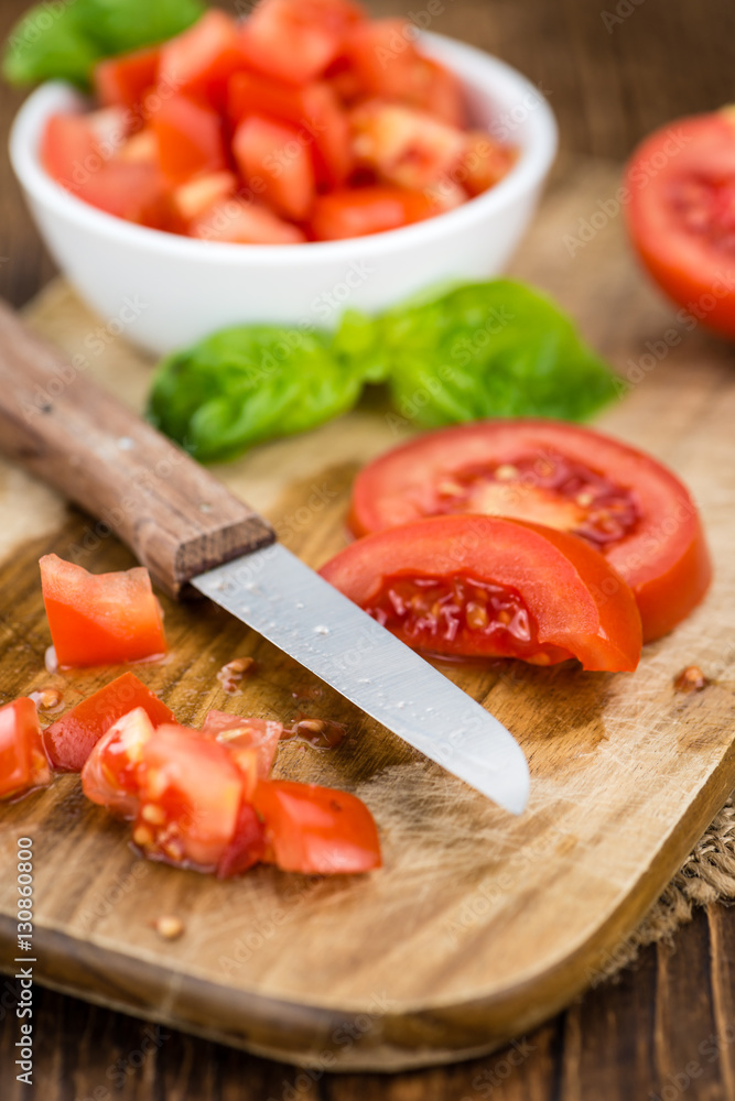 Tomatoes (diced) on wooden background (selective focus) Tomatoes (diced) on wooden background (selective focus)
