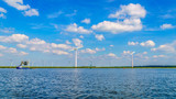 Wind Farm with Two and Three bladed Wind Turbines along the Shore of Veluwemeer in the Netherlands