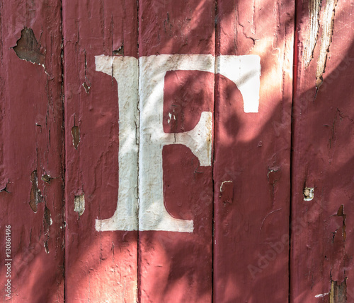 F on red-Painted Wood Siding