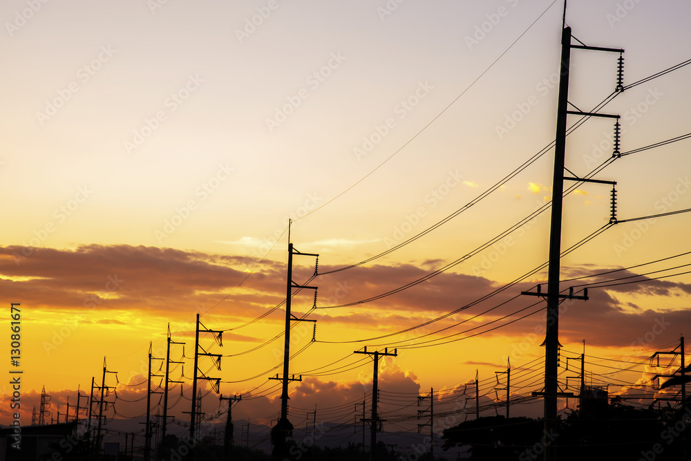 High voltage tower of colorful sky at evening
