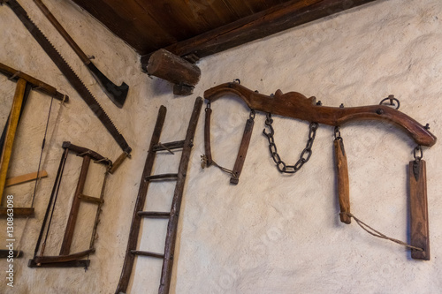 Old agricultural tools hanging on the wall