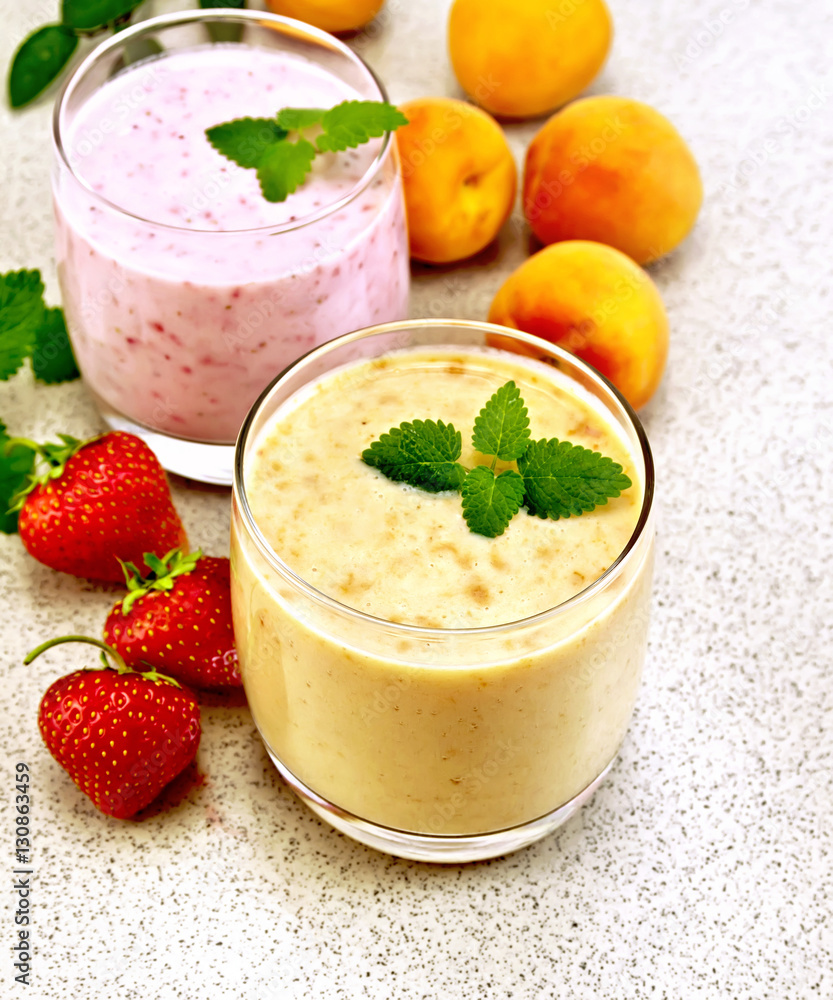 Milkshake apricot and strawberry on granite table Milkshake apricot and strawberry on granite table