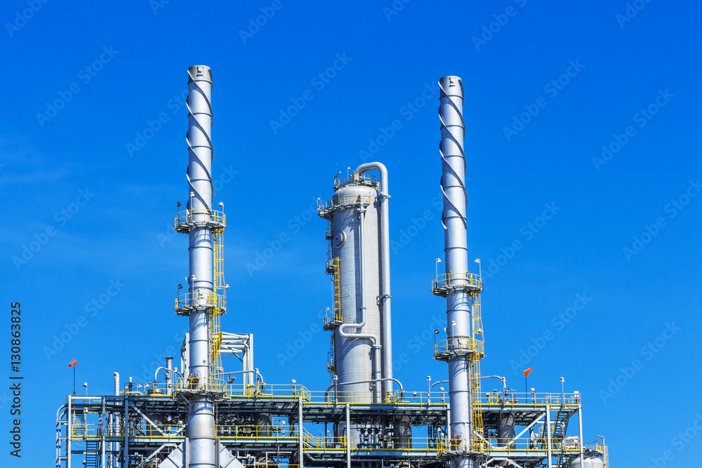 Refinery tower in petrochemical industrial plant with cloudy sky