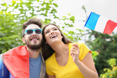 Emotional soccer fans with France flag, outdoors