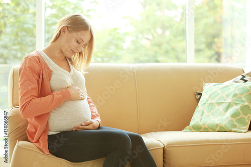 Pregnant woman sitting on c...