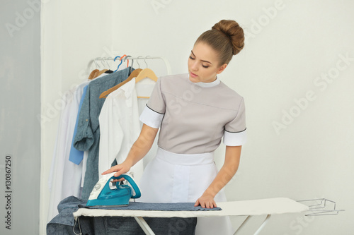 Chambermaid ironing clothes...