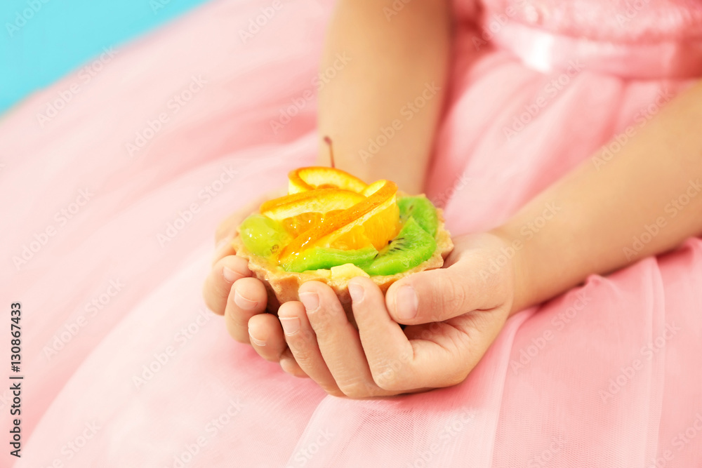 Close up view of little girl's hands with tasty cake Close up view of little girl's hands with tasty cake