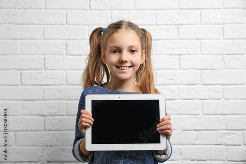Cute girl with tablet compu...