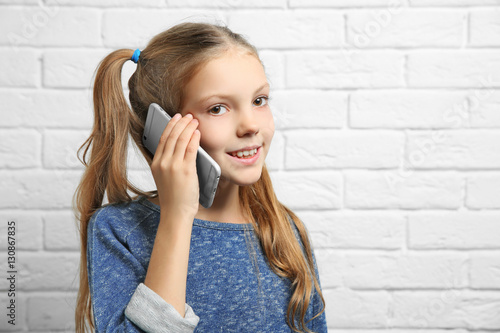Cute girl talking by mobile...