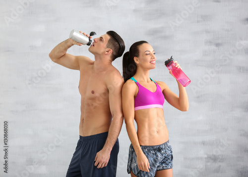 Young sporty couple drinkin...