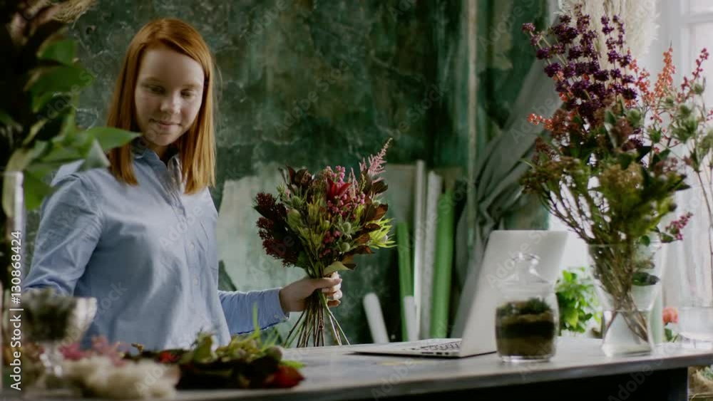 ginger florist creaiting bouqet near table in office ginger florist creaiting bouqet near table in office