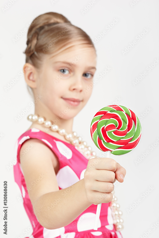 Girl shows a beautiful large candy
