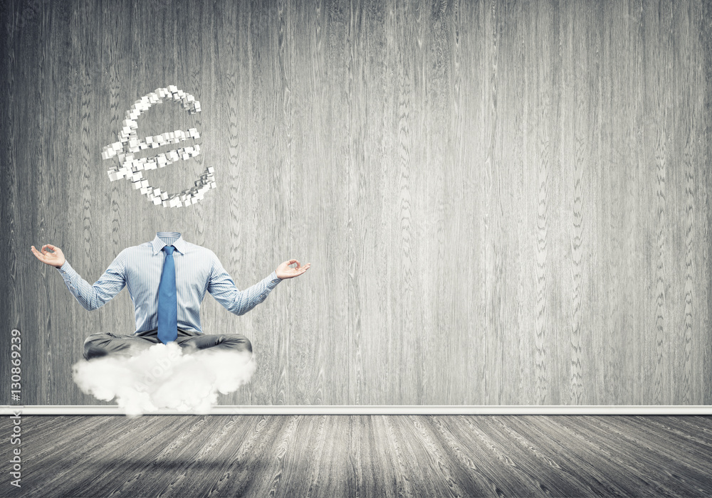 Headless meditating businessman