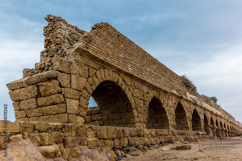 Spectacular view of the ruins of the Roman aqueduct on the beach