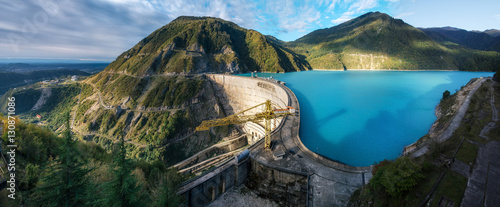 The Enguri hydroelectric power station HES. The wide Inguri River Jvari Reservoir next to Enguri Dam, surrounded by mountains, Upper Svaneti, Georgia. One of the highest concrete arch dam in the world photo