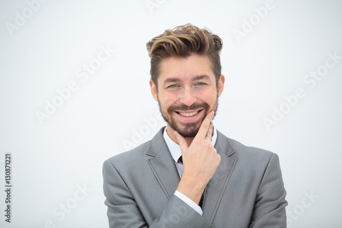 Close up portrait of a smiling handsome business man over white