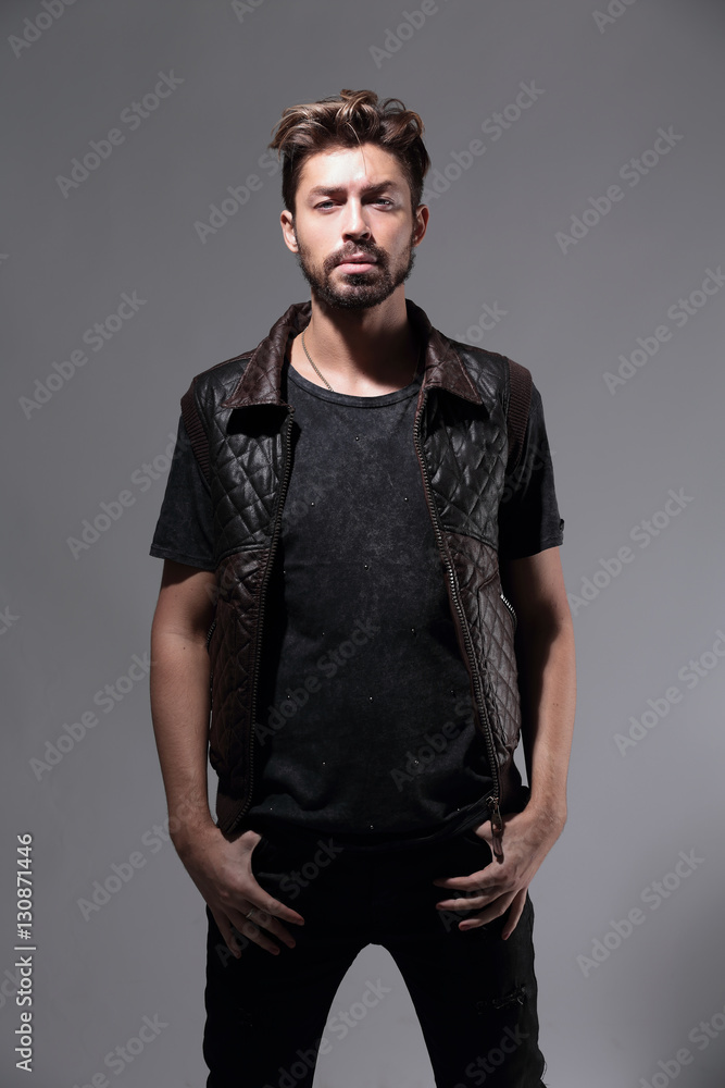 Fototapeta premium Portrait of a pensive handsome man over gray background