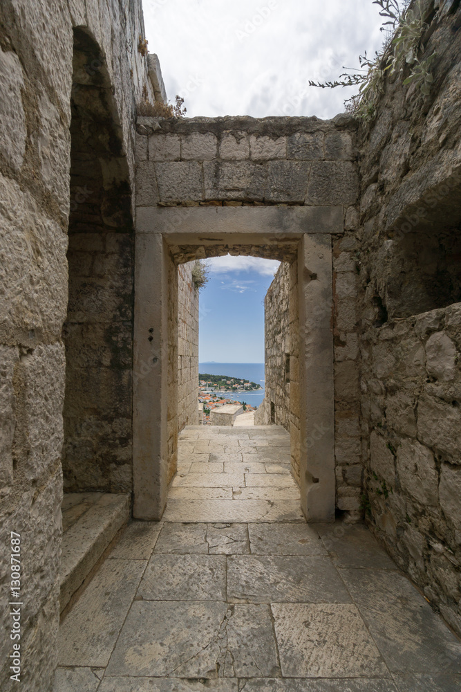 Looking through the doorway of the historic stone fortress, Spanjola Fortress on the island of Hvar in Croatia.
