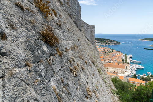 Close up of the city walls of Hvar Town in Croatia with the town visable in the background. photo