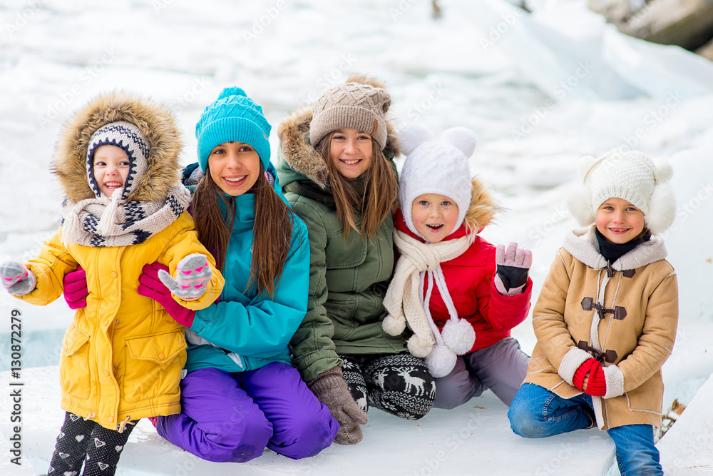 Group of young girls sitting at the ice block