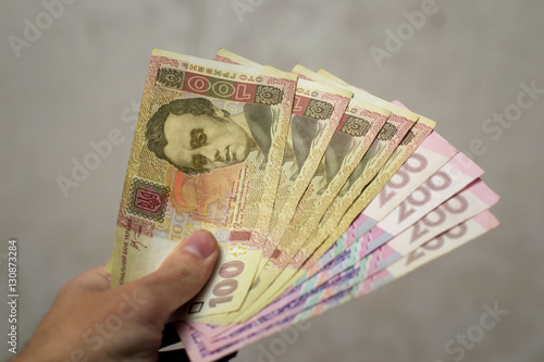 Hand holding ukrainian money