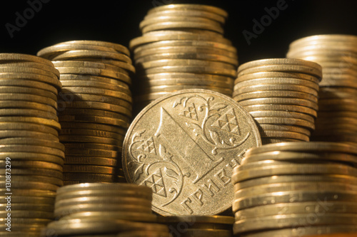 Close up of golden coins heap on black background photo