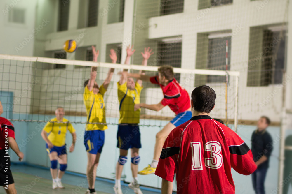 Indoors match between yellow and red uniform teams