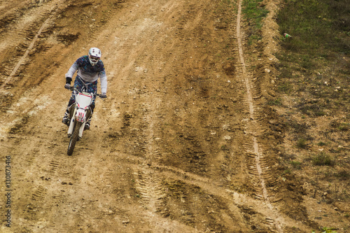 Bike rider moves through dirt at motocross