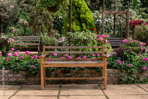 Fototapeta Naklejka Na Ścianę i Meble -  wooden table set in a flower garden