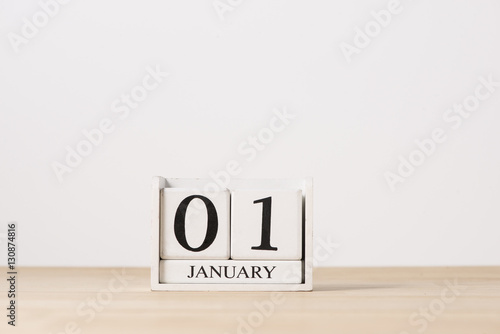 January 01 cube calendar on wooden table with empty space for te