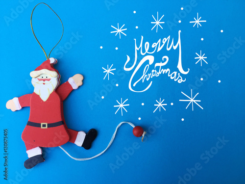 Santa Claus home decoration toy Merry christmas on blue background photo