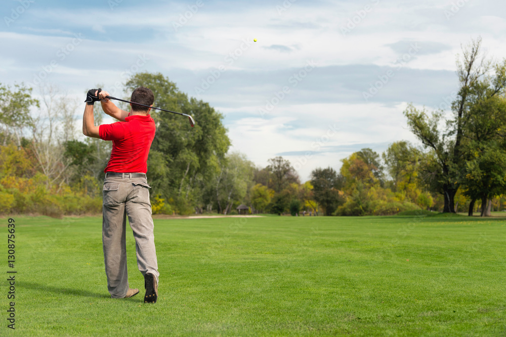 Golfer hits the ball