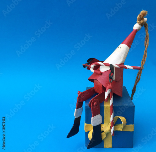 Santa Claus home decoration toy Merry christmas on blue background photo