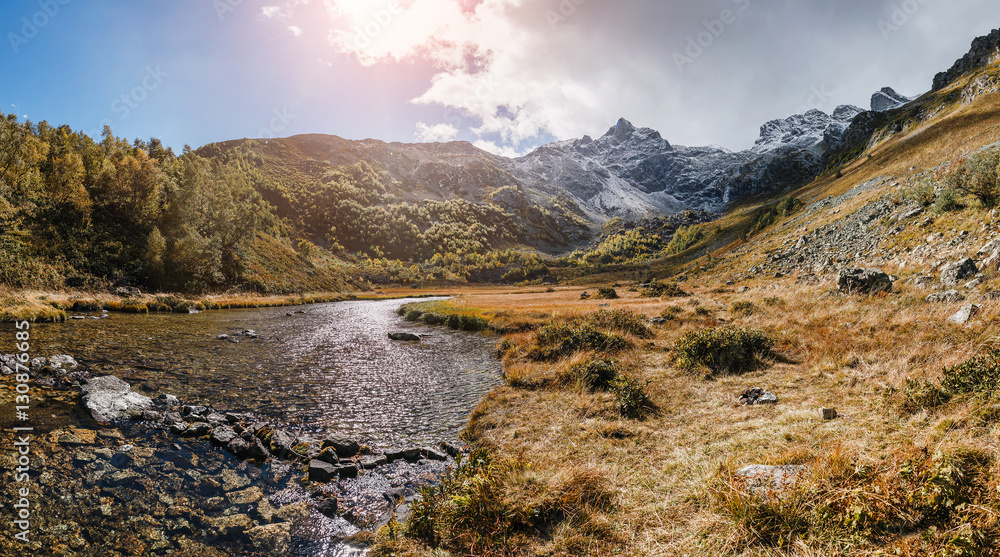 Alpine lake at the sunset at autumn. Arkhyz, Karachay-Cherkessia, Greater Caucasus, Russia.